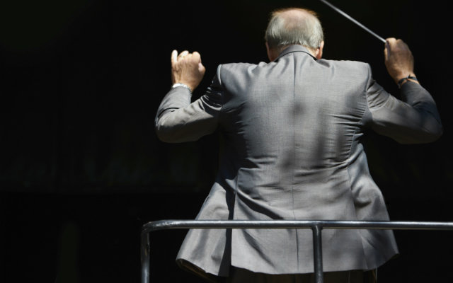 Image of a conductor conducting an orchestra