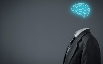 Image of a suit standing with a glowing brain above it