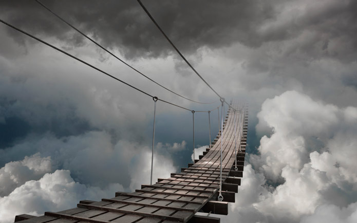 An image of a bridge leading into a stormy sky