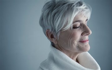 Portrait serene Caucasian senior woman with short white hair and eyes closed
