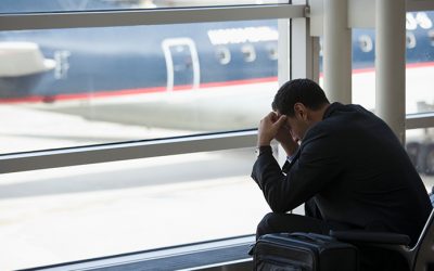 Frustrated Hispanic business traveler waiting in airport